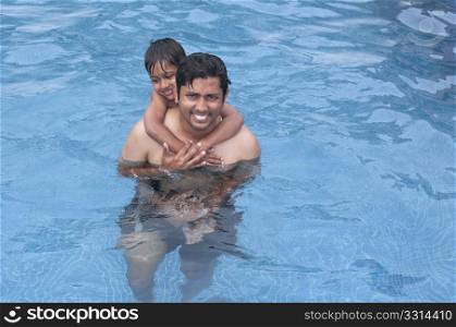 Father and Son having fun at the resport pool