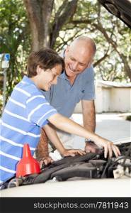 Father and son having fun together repairing the family car.
