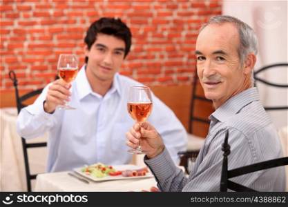 Father and son having lunch