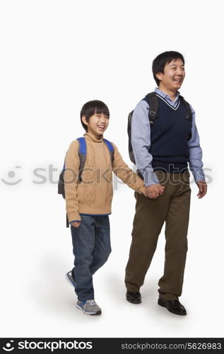 Father and son holding hands and walking