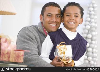 Father And Son Hugging,Holding Christmas Gift
