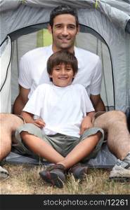 Father and son in a tent