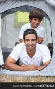 Father and son in a tent