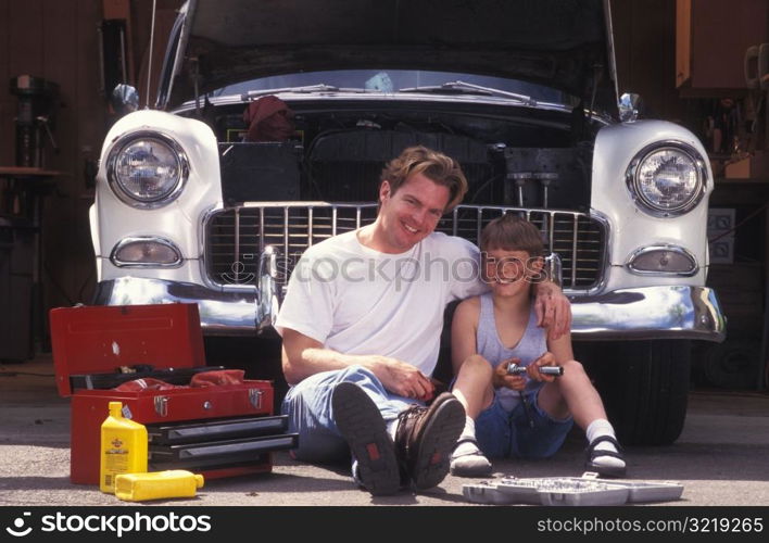 Father and Son in Driveway with Car