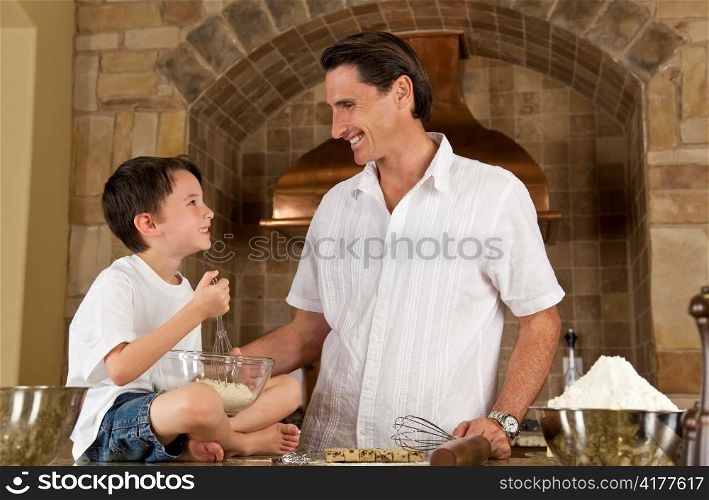 Father and Son In Kitchen Cooking Baking Cookies