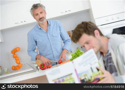 Father and son in kitchen together