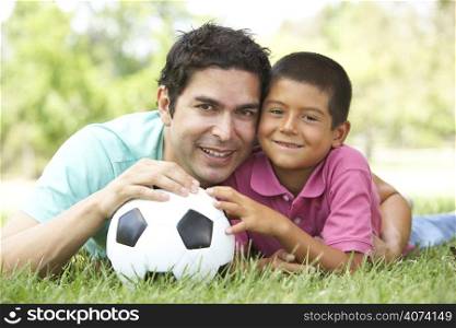 Father And Son In Park With Football