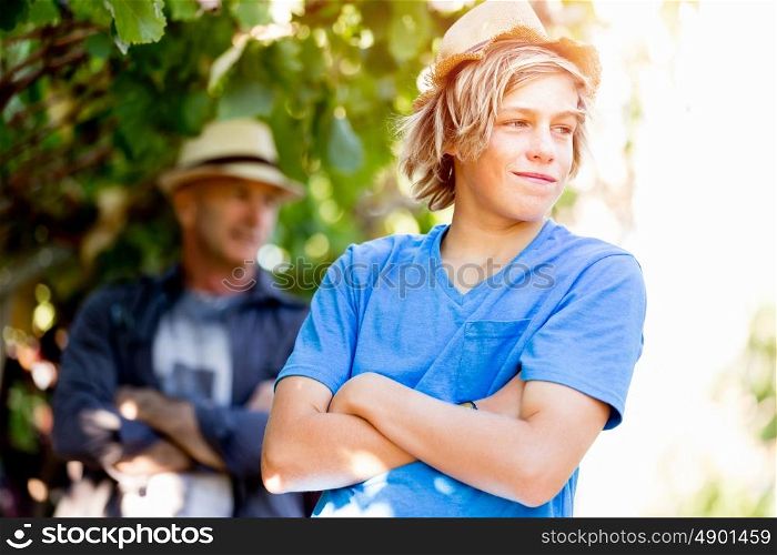 Father and son in vineyard. Father and son standing in vineyard
