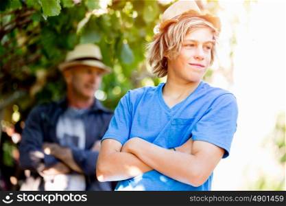Father and son in vineyard. Father and son standing in vineyard