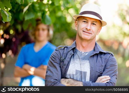 Father and son in vineyard. Father and son standing in vineyard