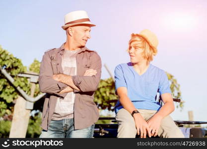 Father and son in vineyard. Father and son standing next to car in vineyard