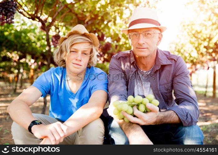 Father and son in vineyard. Father and son together in vineyard