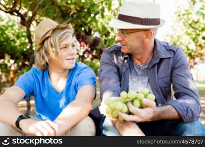 Father and son in vineyard. Father and son together in vineyard