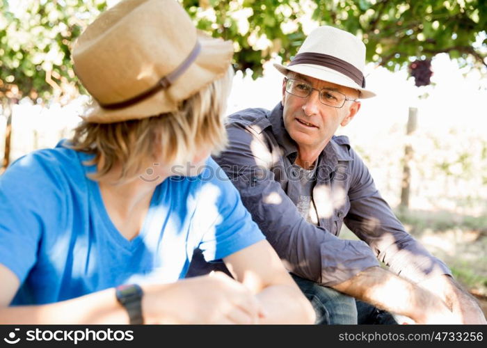 Father and son in vineyard. Father and son together in vineyard