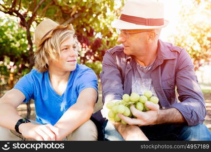 Father and son in vineyard. Father and son together in vineyard