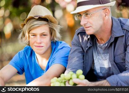 Father and son in vineyard. Father and son together in vineyard