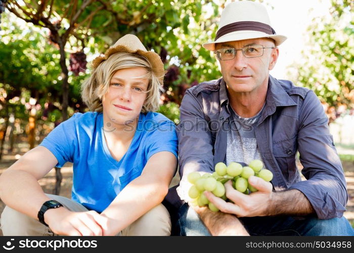 Father and son in vineyard. Father and son together in vineyard