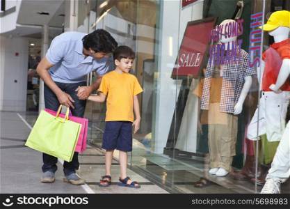 Father and son out for shopping in a mall