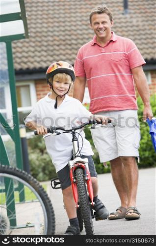 Father and Son outside school with bicycle
