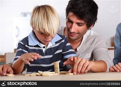 Father and son playing domino