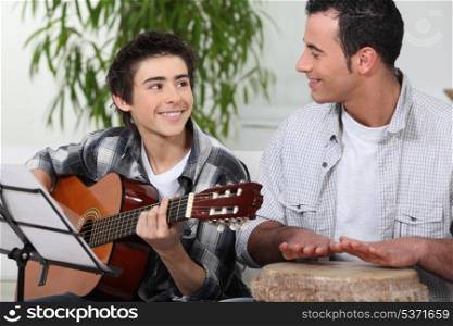 Father and son playing music