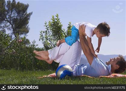 Father and son playing on a picnic rug