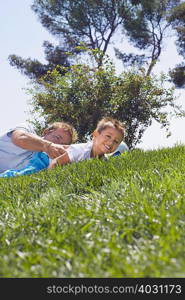 Father and son playing on grass