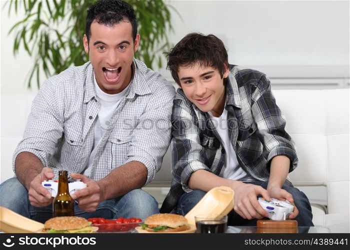 father and son playing to video games