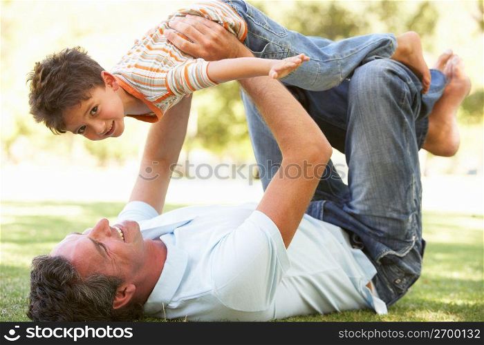 Father And Son Playing Together In Park
