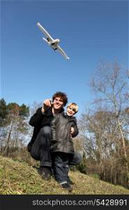 Father and son playing with an aeroplane