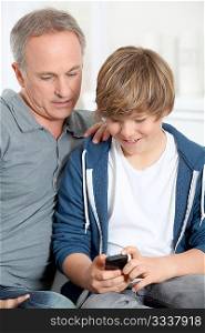 Father and son playing with mobile phone