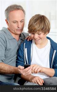 Father and son playing with mobile phone