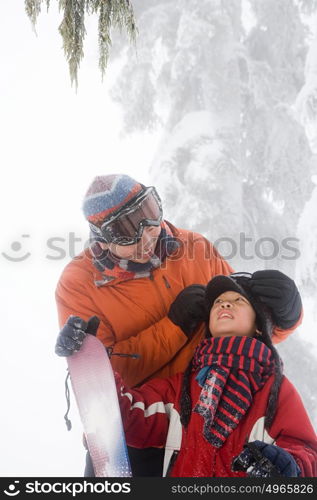 Father and son preparing for skiing