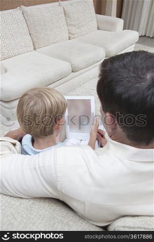 Father and son read a digital book