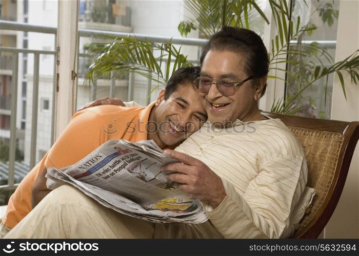 Father and son reading the newspaper