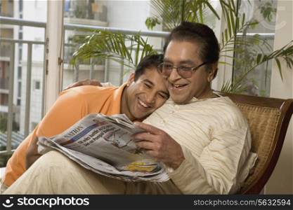 Father and son reading the newspaper