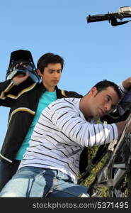 Father and son repairing motorbike