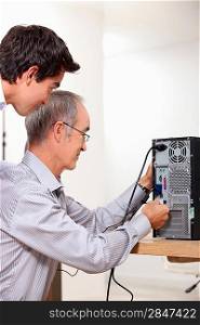Father and son repairing PC