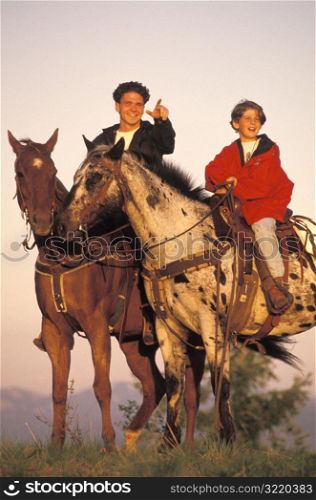 Father and Son Riding Horses Together