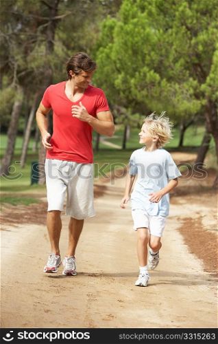 Father and son running in park