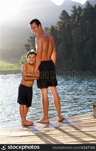 Father and son standing on jetty