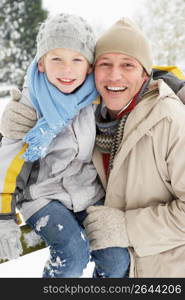 Father And Son Standing Outside In Snowy Landscape