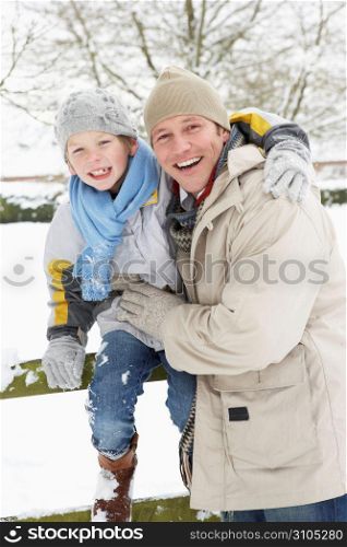 Father And Son Standing Outside In Snowy Landscape