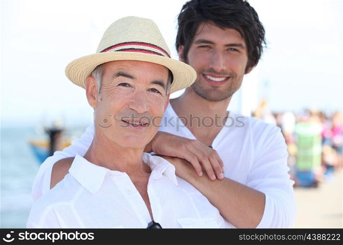 Father and son stood on pier