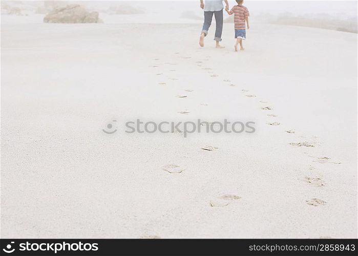 Father and Son Strolling on Beach