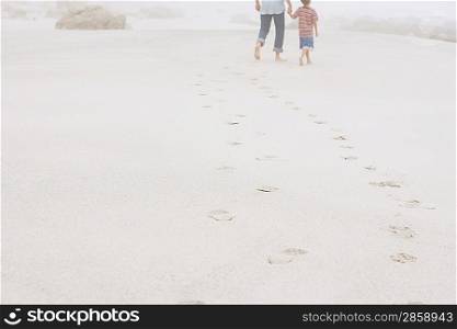 Father and Son Strolling on Beach