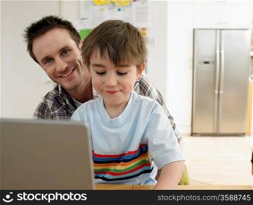Father and Son Using Laptop Together