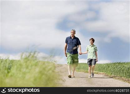 Father and son walking down a road