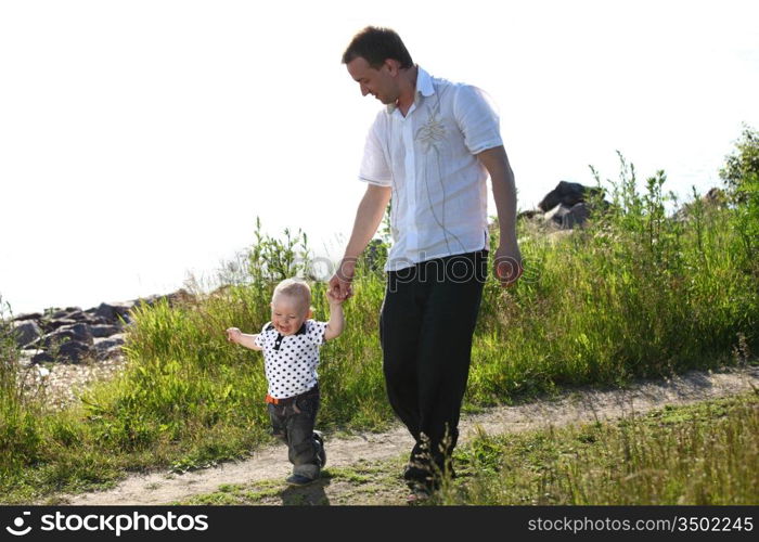 father and son walking on grass