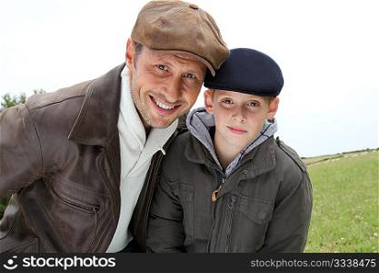 Father and son wearing cap